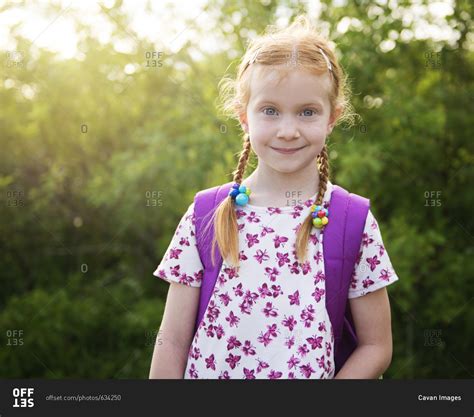 Portrait Of Confident Girl With Backpack At Park Stock