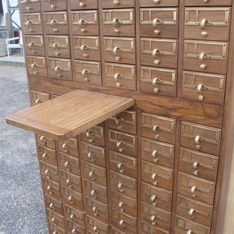 12 drawer oak card index filing cabinet, wine rack the cabinet has 4 rows of 3 drawers, each with a brass handle / name plate holder the cabinet is in sound original a peculiar card index cabinet from the 1970s. Vintage Midcentury Library 90 Drawer Oak Card File Cabinet ...