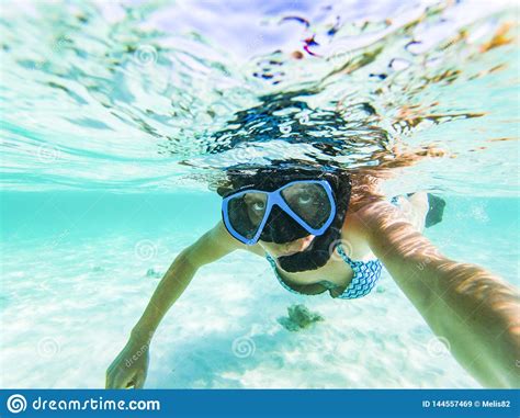 Woman Taking An Underwater Selfie While Snorkeling In Crystal Clear Tropical Water Stock Image