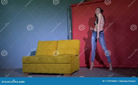 A Slim Model Stands Near The Couch And Slowly Undresses Slow Motion