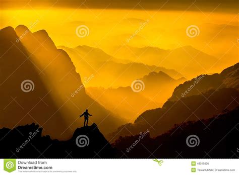 Silhouette Of Man On Top Of Mountain With Sunset Conceptual Scene