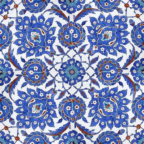 An Intricate Blue And White Tile Design With Red Orange And Green