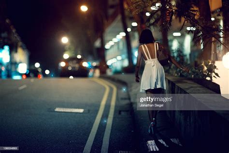 Woman Walking Down Lonely Road High Res Stock Photo Getty Images