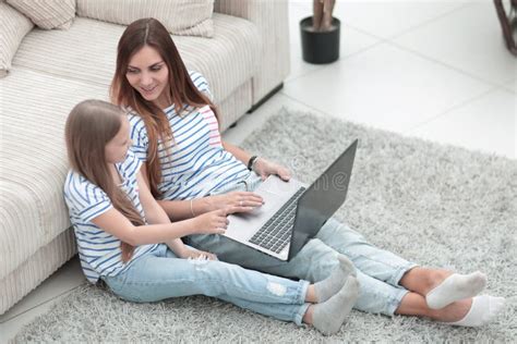 Mother And Daughter Sitting On The Floor In A Cozy Living Room Stock Image Image Of Floor
