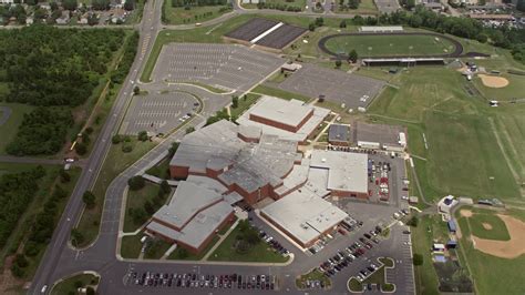 48k Stock Footage Aerial Video Tilting To Birds Eye Of High School In