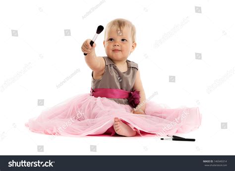 Adorable Little Baby Girl In Pink Dress Sitting On Floor
