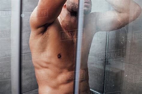 Cropped View Of Muscular Man Taking Shower In Bathroom Stock Photo Dissolve