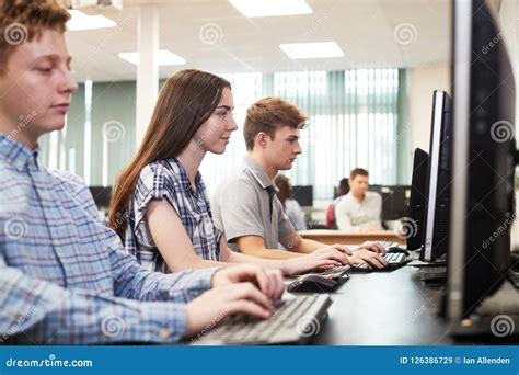 Group Of High School Students Working Together In Computer Class Stock