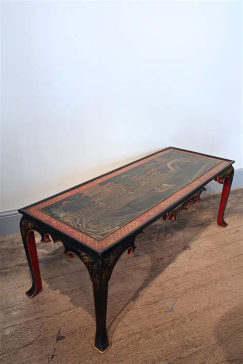 A coffee table is a long, low table which is designed to be placed in front of (or next to) a sofa or upholstered chairs to support beverages, magazines, books, decorative objects, and other small items to be used while sitting, such as beverage coasters. 1930s Spanish Chinoiserie Coffee Table - Coffee / Low Tables