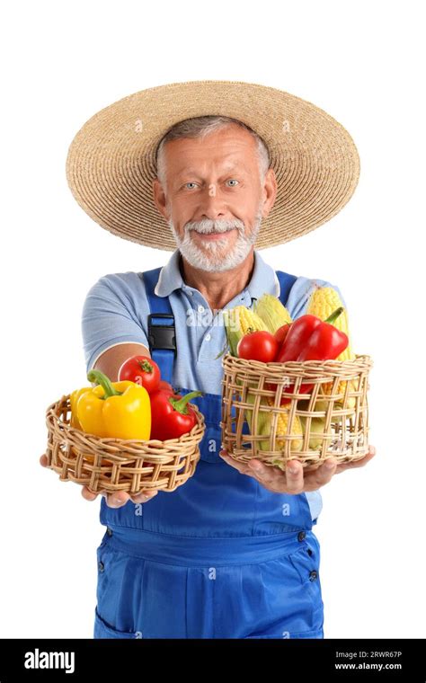 Mature Male Farmer With Wicker Baskets Full Of Different Ripe