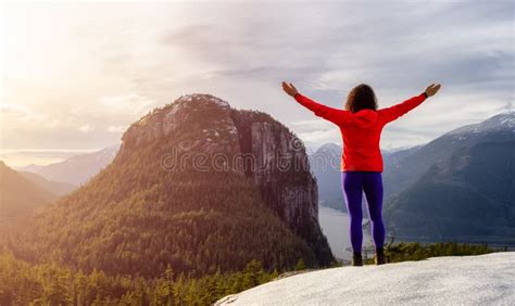 Adventurous Girl Hiking In The Mountains During A Sunny Autumn Sunset