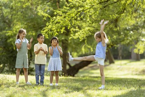 Group Of Asian And Caucasian Kids Having Fun In The Park Stock Photo