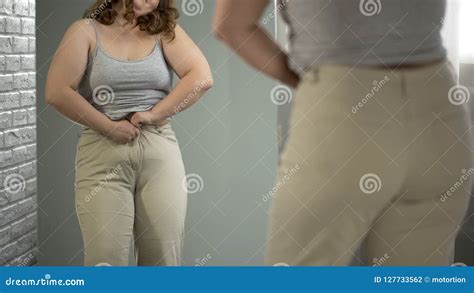 Overweight Lady Having Difficulties With Getting Into Her Pants Obesity Issue Stock Photo