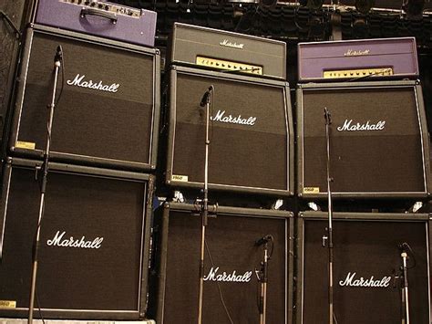 Several Marshall Amps Are Lined Up Against The Wall