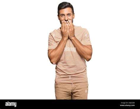 Handsome Hispanic Man Wearing Casual Clothes Laughing And Embarrassed Giggle Covering Mouth With