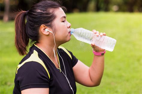 Young Woman Drinking Naturel Water From Bottle After Exercise Stock