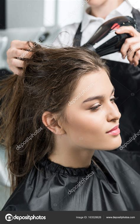 Hairdresser Drying Hair Of Woman — Stock Photo © Dimabaranow 163528626