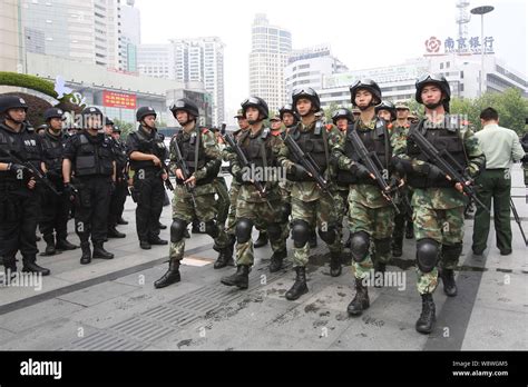 Swat Police Officers Armed With Guns Patrol At The Square Of The Shanghai Railway Station In