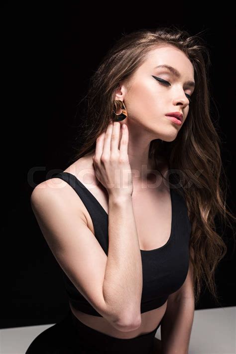 Relaxed Woman Gently Touching Neck With Closed Eyes Isolated On Black
