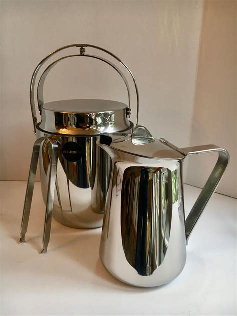 Easy to clean, dishwasher safe, hand washing is recommended, spring action. Alessi Ice Bucket Tongs and Pitcher For Sale at 1stdibs