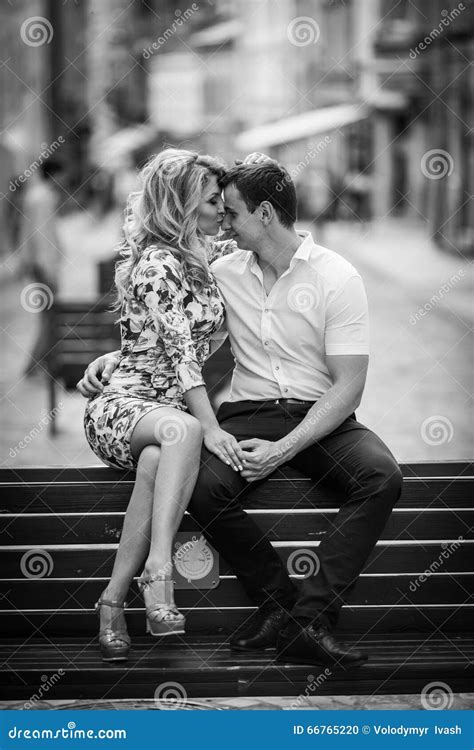 Happy Stylish Newlywed Couple Posing On Wooden Bench In Town B W Stock Photo Image Of Couple