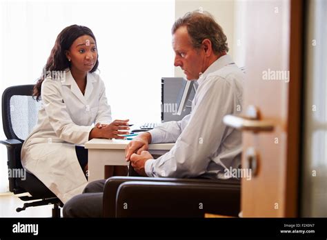 Female Doctor Treating Patient Suffering With Depression Stock Photo