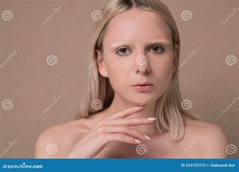 A Pretty Blonde Girl With Naked Shoulders Looking Serious Stock Image