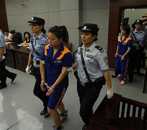 Woman In Prisoners Suits Handcuffed And Shackled Are Led To Court Chinese Press Release