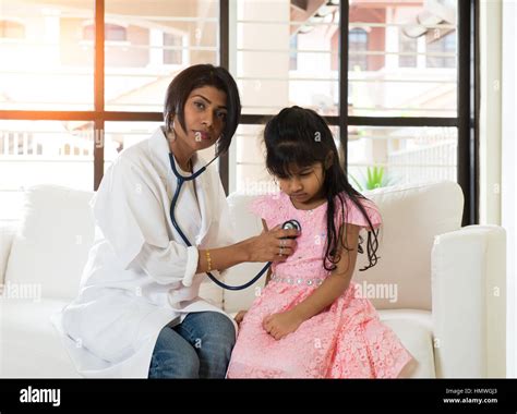 Indian Female Doctor Treating Young Girl Patient Stock Photo Alamy