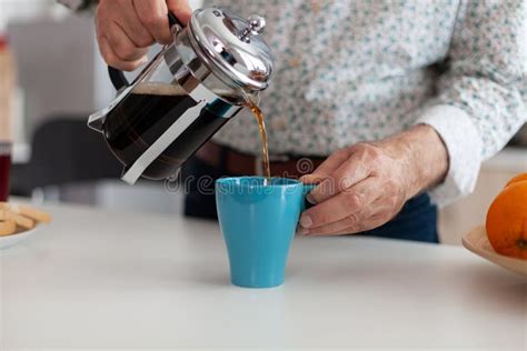 Close Up Of Elderly Man Hands Pouring Coffee In Cup Stock Photo Image