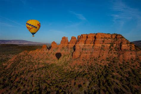 Hot Air Ballooning Over Sedona Arizona Showing Balloon And Butte Stock