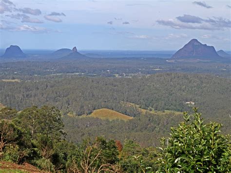 The glass house mountains are a group of thirteen hills that rise abruptly from the coastal plain on the sunshine coast, queensland, australia. Glass House Mountains, QLD - Aussie Towns