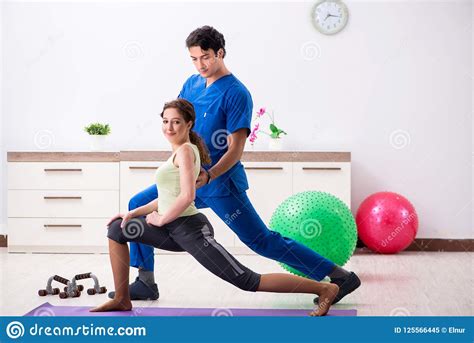 The Fitness Instructor Helping Sportsman During Exercise Stock Image