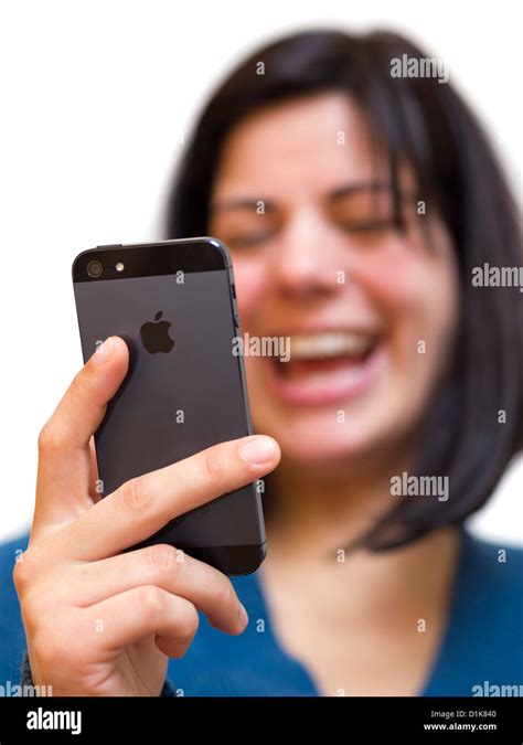 Smiling Young Woman Holding An Iphone 5 Stock Photo Alamy