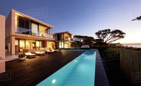 Modern Luxury Home Showcase Deck And Swimming Pool At Sunset Stock
