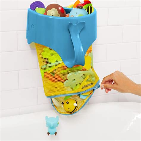 A Childs Bathtub With Toys In It And A Hand Holding The Handle