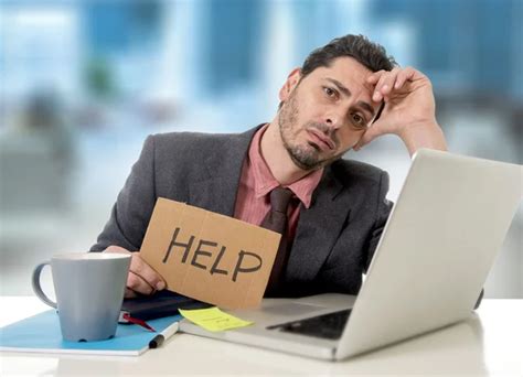 Sad Businessman At Office Desk Working On Computer Laptop Asking For