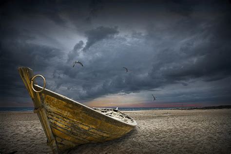 Boat With Gulls On The Beach With Oncoming Storm Photograph By Randall