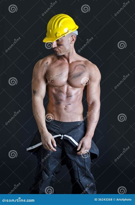hot muscular construction worker shirtless carrying barrel royalty free stock image