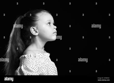 Black And White Portrait Of Pretty Little Girl On Dark Background Stock