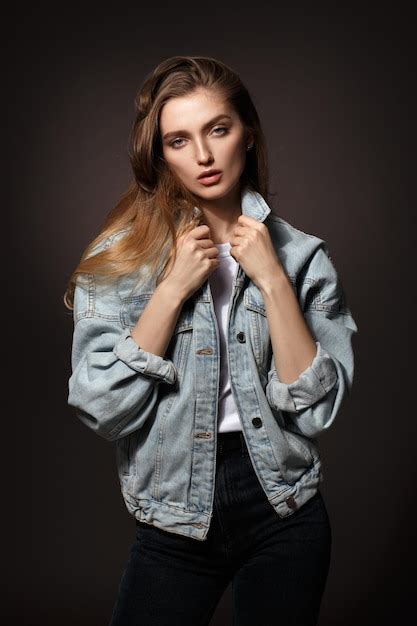 Premium Photo Gorgeous Brunette Girl With Long Flowing Hair Dressed In Jeans Jacket And Jeans