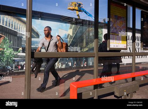 Local man passes a hoarding showing aspiration and consumerism of