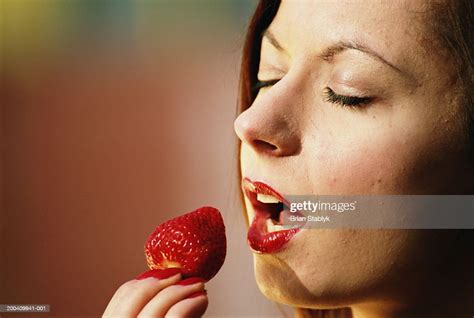 Young Woman About To Eat Strawberry Eyes Closed Closeup Photo Getty