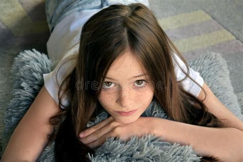 Innocent Teenager Girl Looking Shy With Hands Near Her Face Stock Image