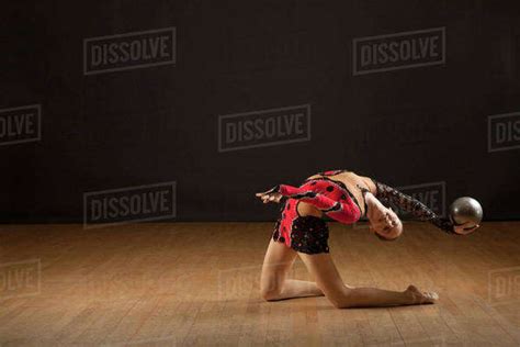Gymnast Bending Backwards Holding Ball Stock Photo Dissolve