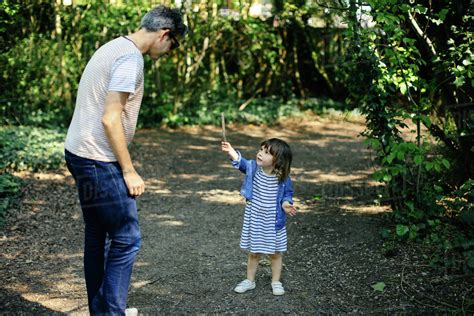 Father And Little Girl Enjoying Nature Walk Stock Photo Dissolve