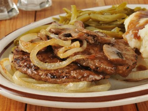 Smoked hamburger steak recipe with mushroom & onion brown gravy, garlic mashed potatoes, and roasted green beans. Classic Hamburger Steak With Onions And Gravy Recipe | CDKitchen.com