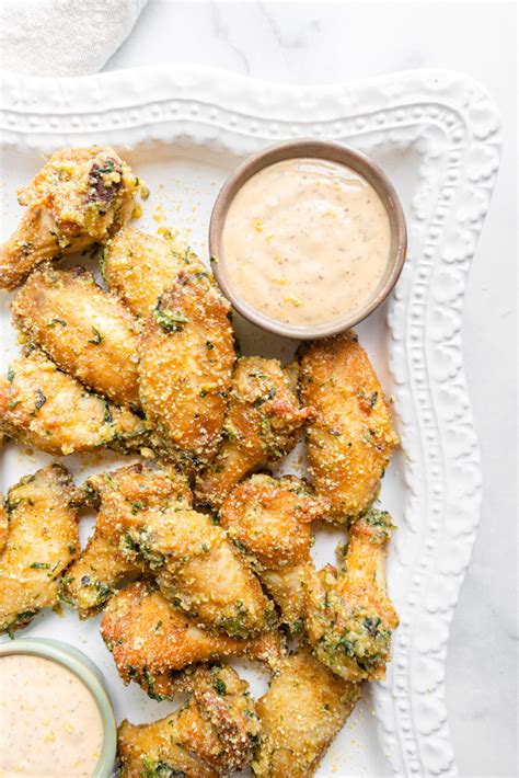 Chicken wings dipped in melted butter and coated with parmesan cheese and herbs bake up into an awesome crispy appetizer for tailgating. Garlic "Parmesan" Chicken Wings (Paleo, Keto, Whole30) - a ...