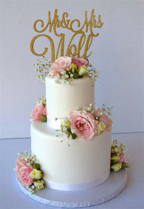 2 Tier White Wedding Cake With Blush Pink Roses On Each Tier And Babys