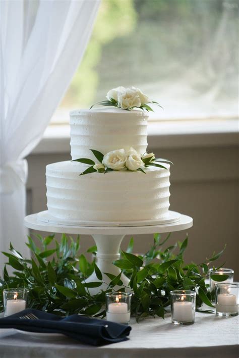 Here are some designs to inspire you. White buttercream cake with greenery and soft blooming ...